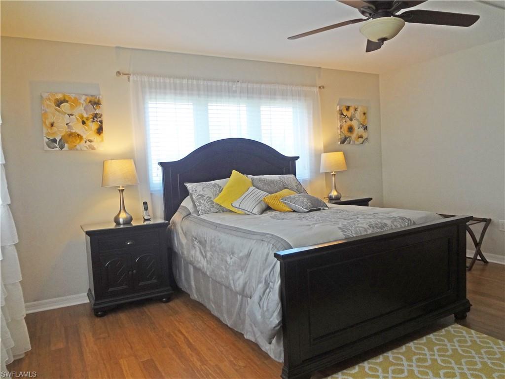 Bedroom with dark wood-type flooring and ceiling fan
