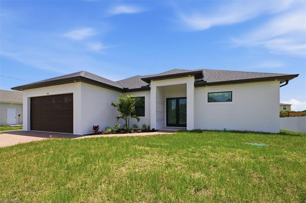 Contemporary white stucco exterior with a dark brown garage door