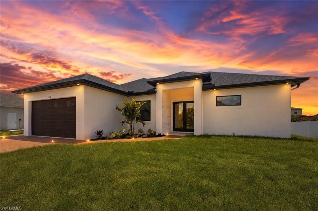 Modern stucco exterior with dark-framed windows and a double-door entry