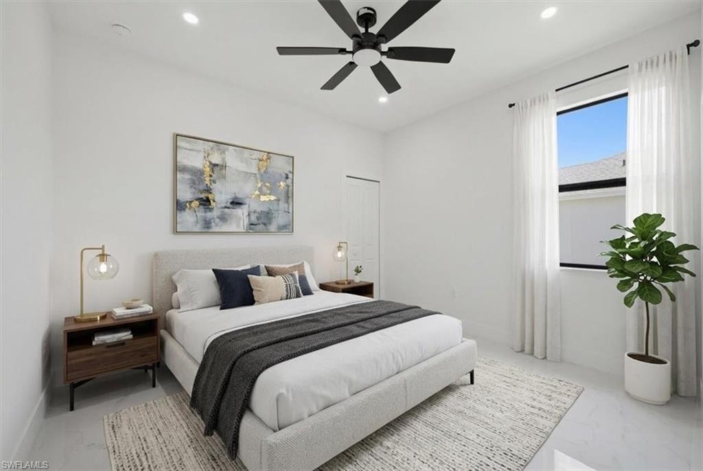 Spacious room featuring a large window with sheer drapes, recessed lighting, and a contemporary ceiling fan