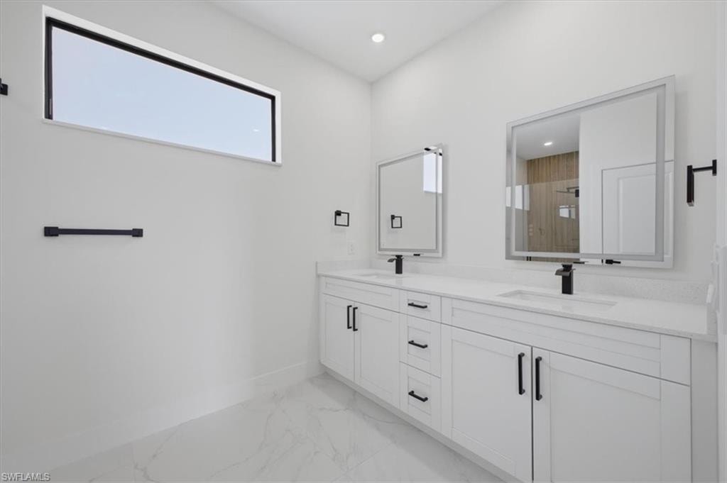 Dual vanity featuring white shaker cabinetry, quartz countertops, and matte black hardware