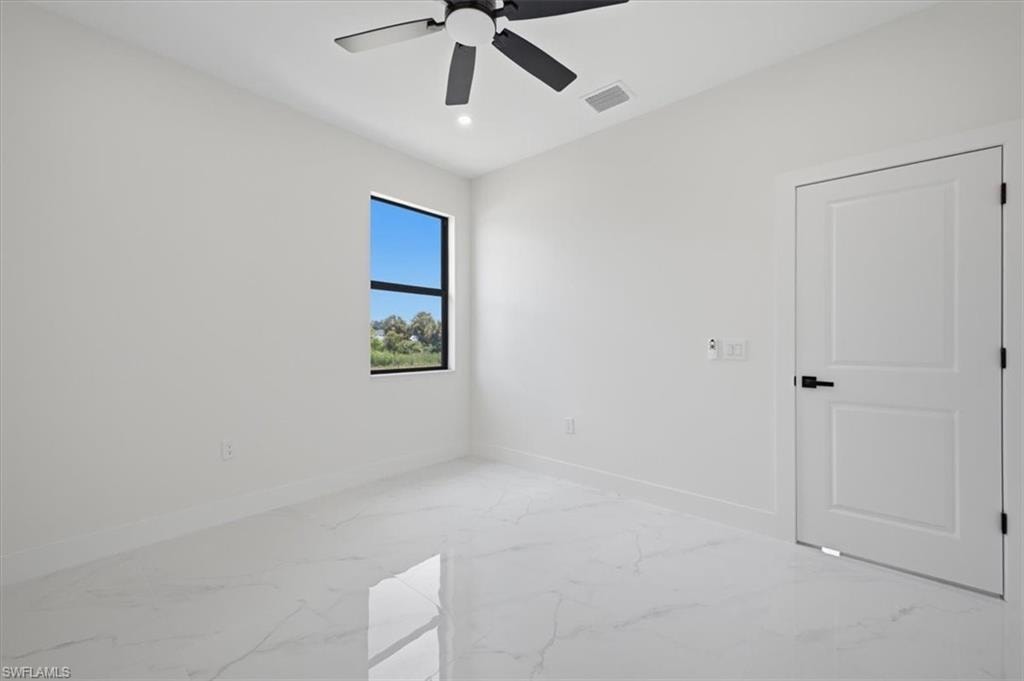 Sleek interior featuring white walls and large format tile flooring