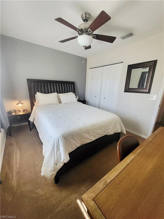 Bedroom featuring carpet, a closet, and a ceiling fan
