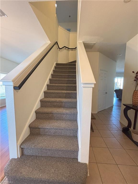 Stairs with tile patterned floors