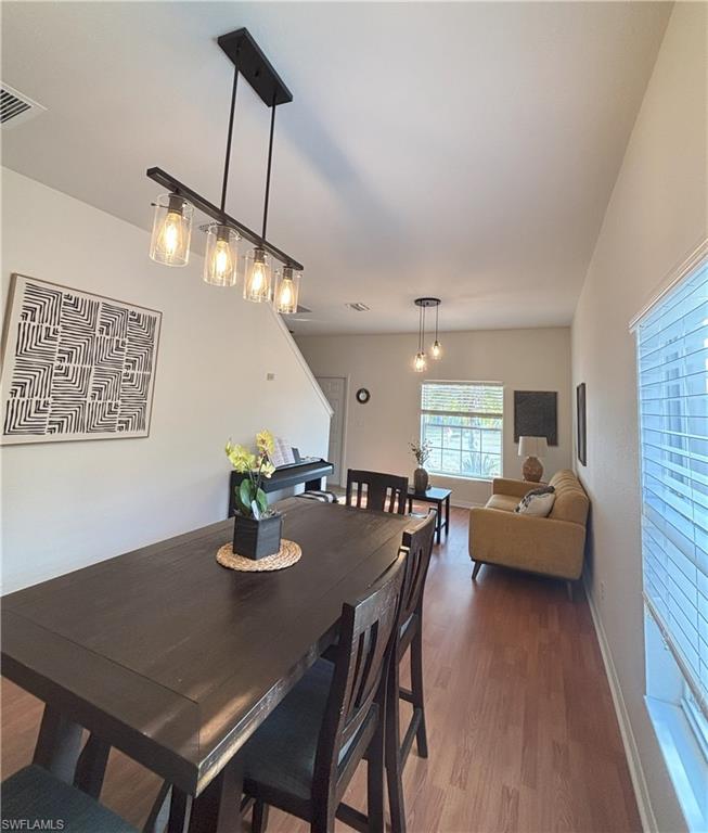 Dining space with wood finished floors and baseboards