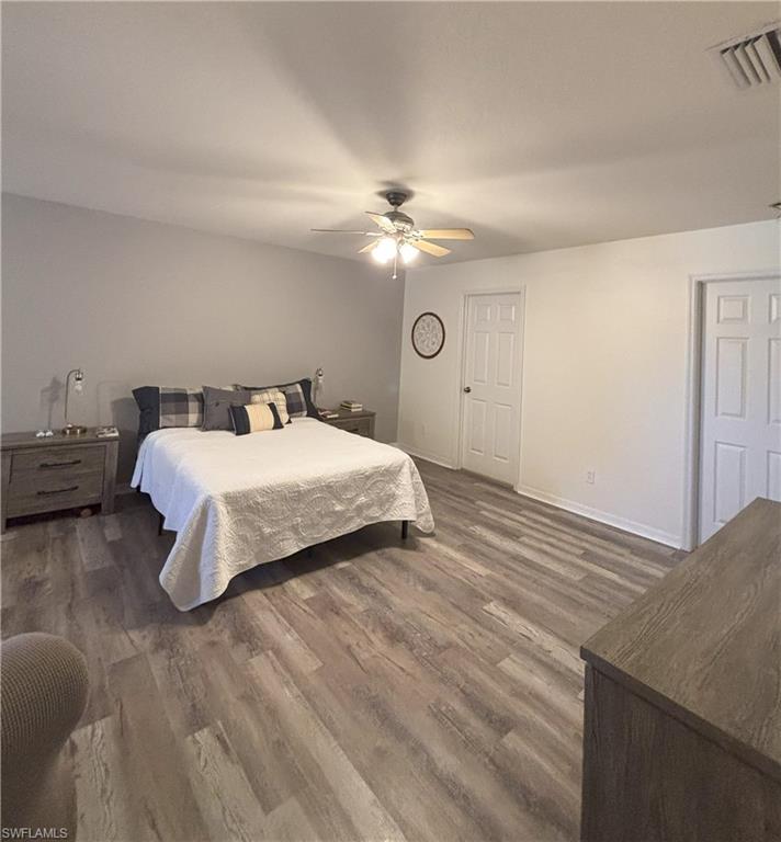 Bedroom featuring a ceiling fan and dark wood-type flooring