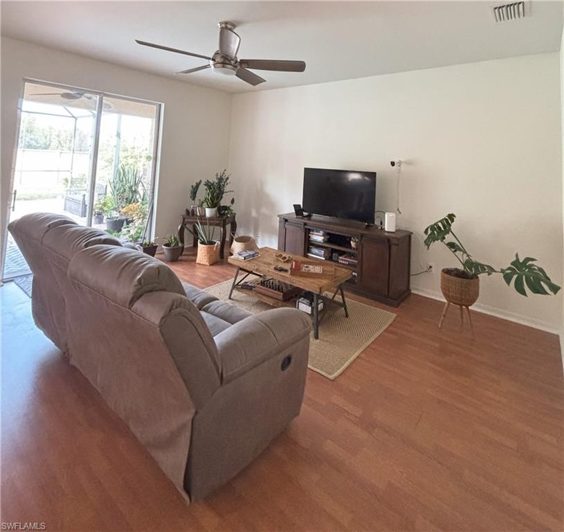 Living area with wood finished floors and a ceiling fan