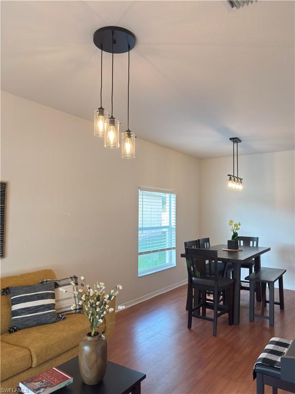 Dining area featuring wood finished floors and baseboards