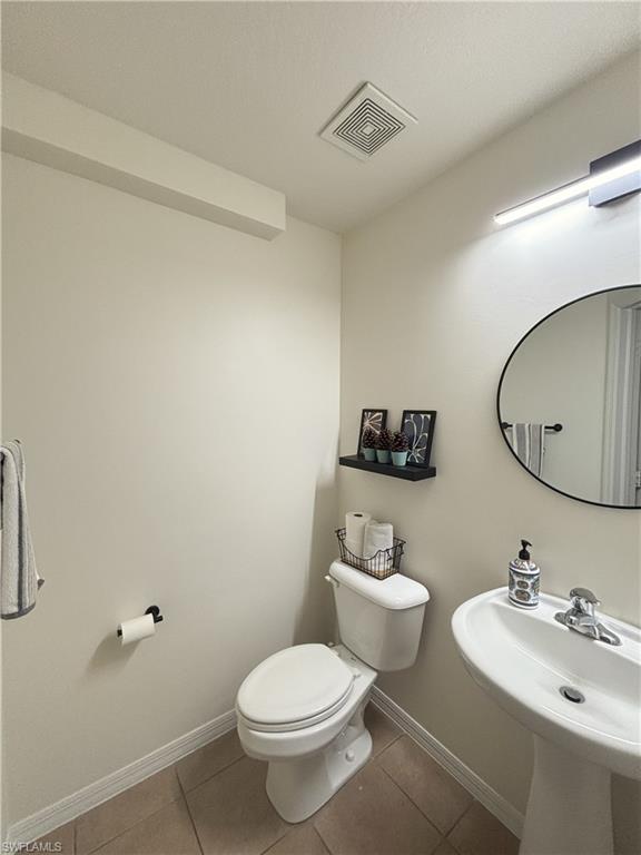 Half bathroom with tile patterned floors