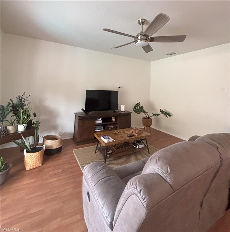 Living room featuring wood finished floors and ceiling fan