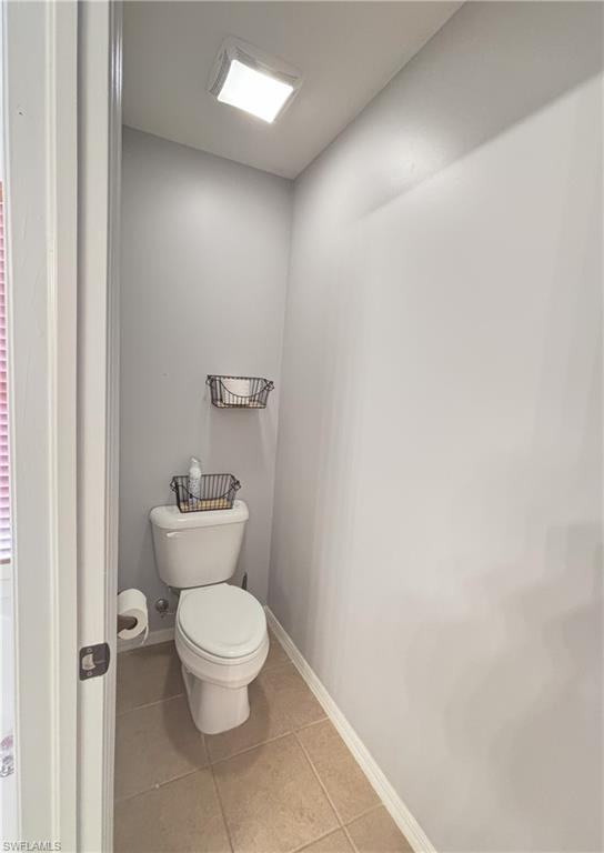 Bathroom featuring light tile patterned floors and baseboards
