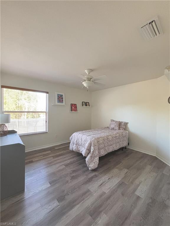 Bedroom featuring a ceiling fan and dark wood-style flooring