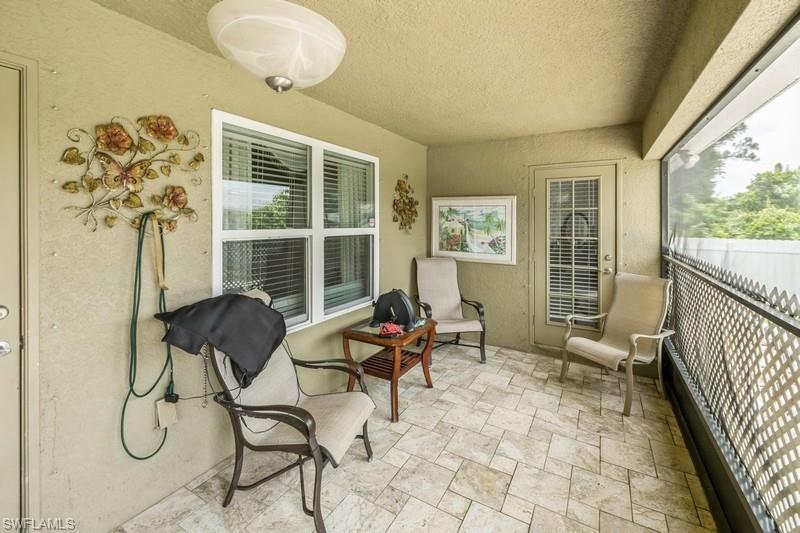 View of patio featuring a sunroom