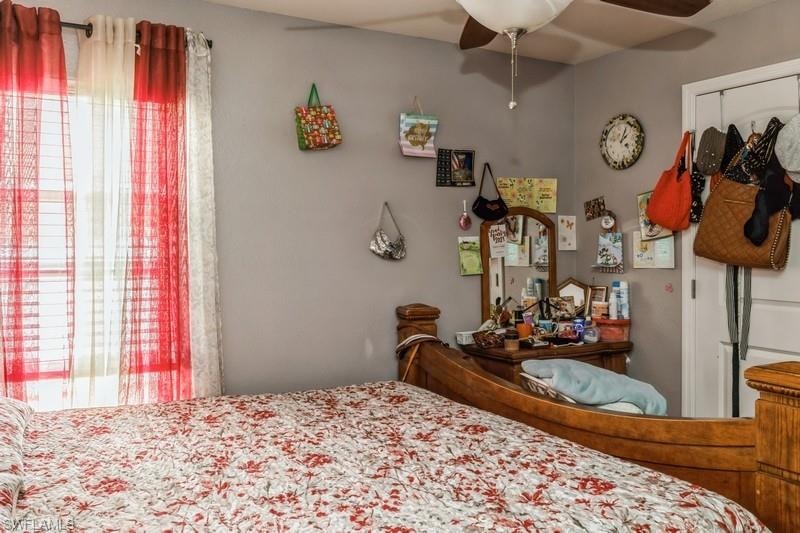 Bedroom featuring ceiling fan and multiple windows