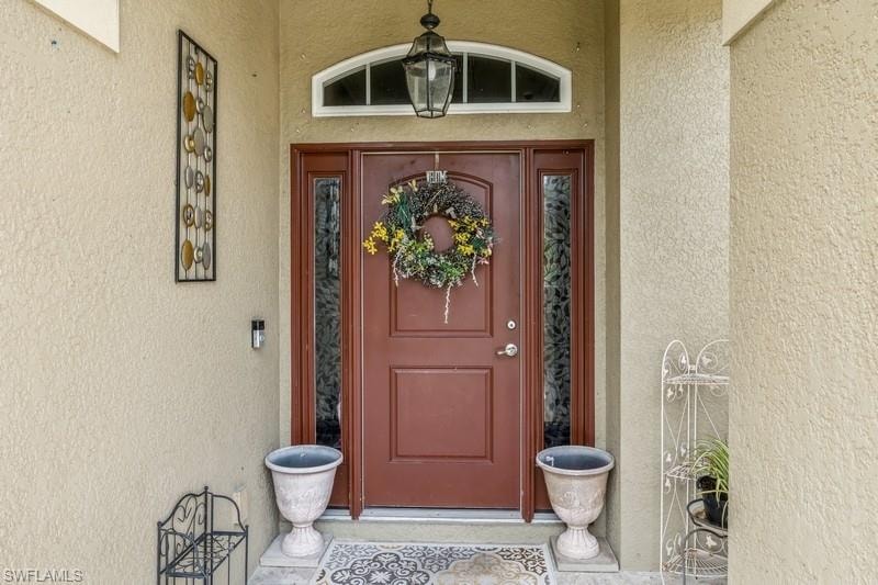 Entrance to property with stucco siding