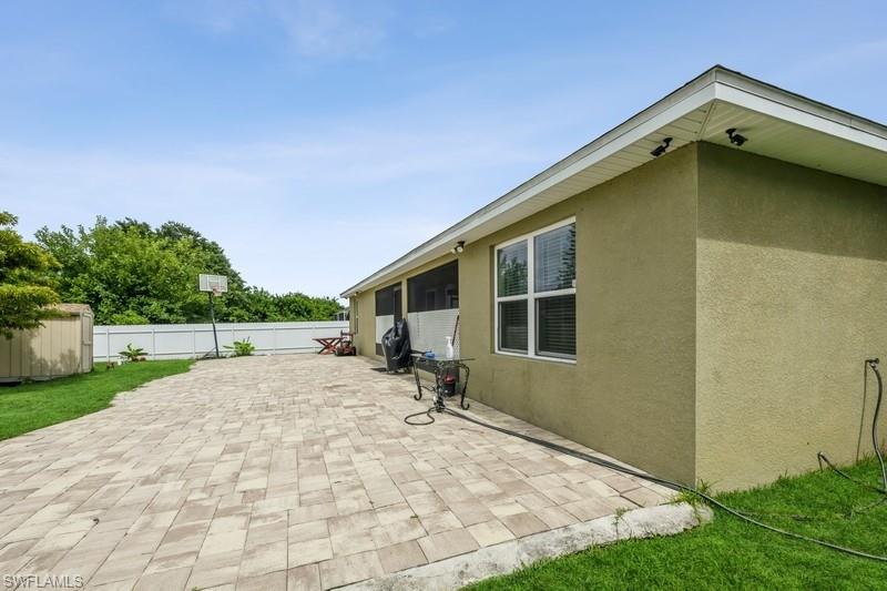 View of patio / terrace featuring a storage shed and a sunroom