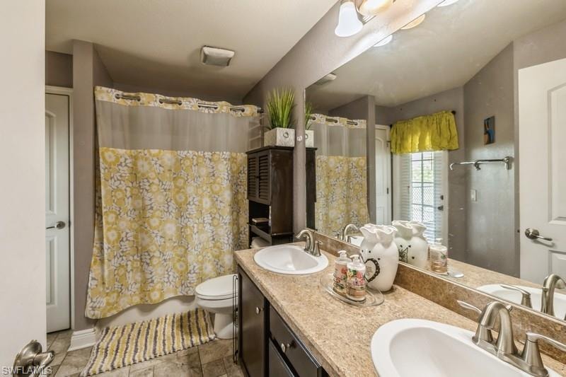 Bathroom with double vanity and shower / tub combo