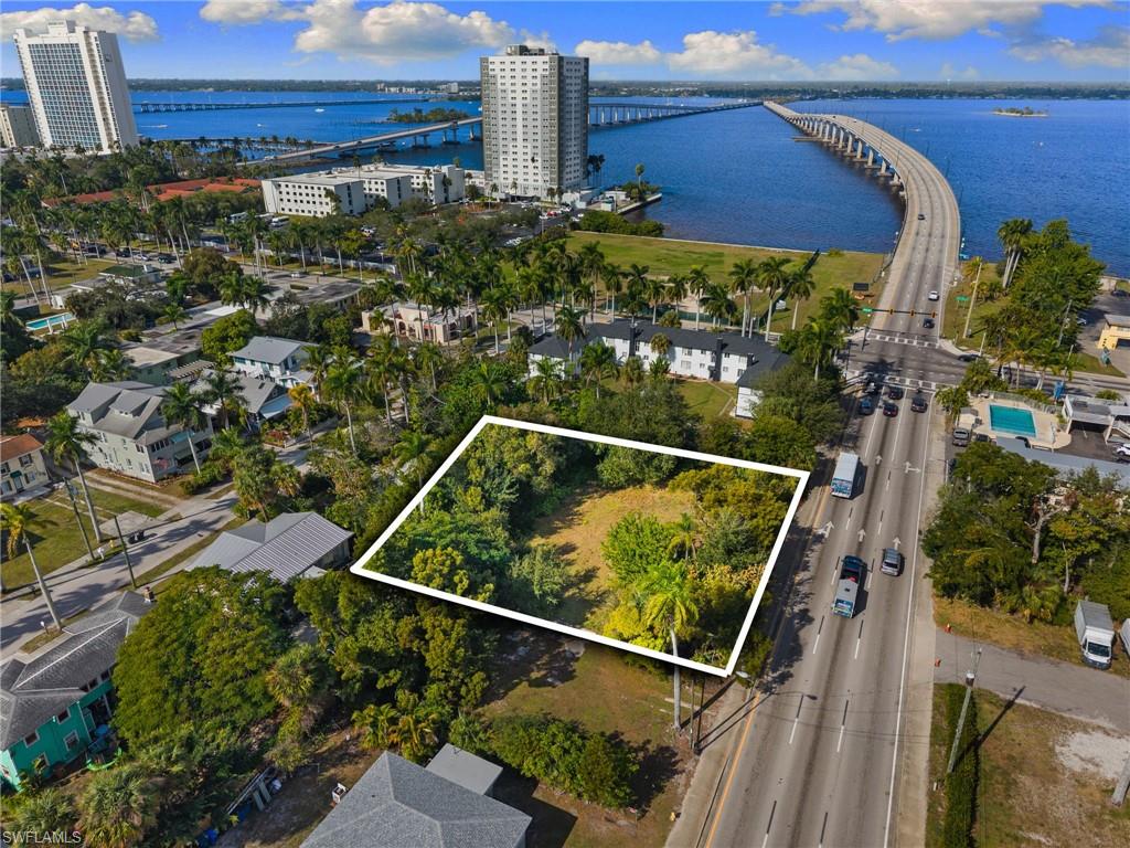 Aerial view of property and surrounding area with a notable bridge, a large body of water, and property boundaries highlighted