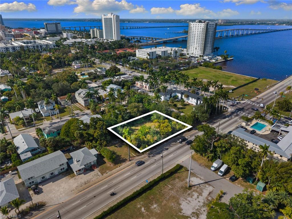 View of urban area with a notable bridge, property boundaries highlighted, and a nearby body of water