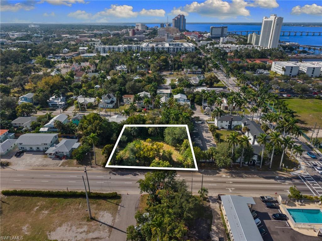 View of urban area featuring property boundaries highlighted and a nearby body of water