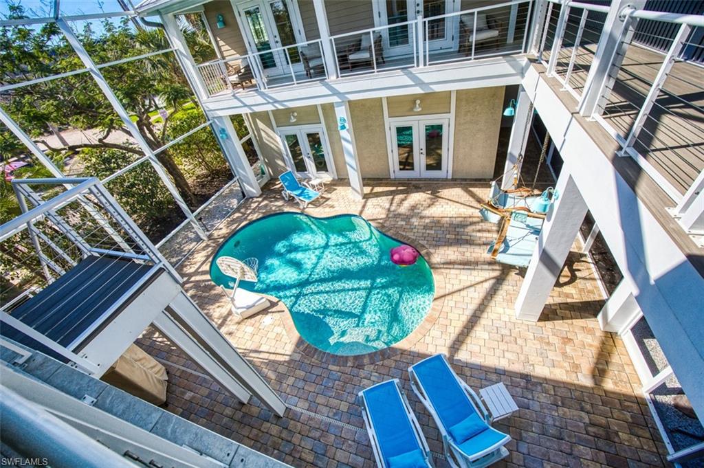 Swimming pool featuring french doors, a patio, and a balcony