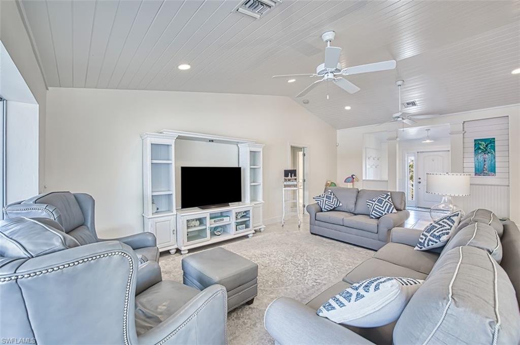 Carpeted living room featuring lofted ceiling, wooden ceiling, and recessed lighting