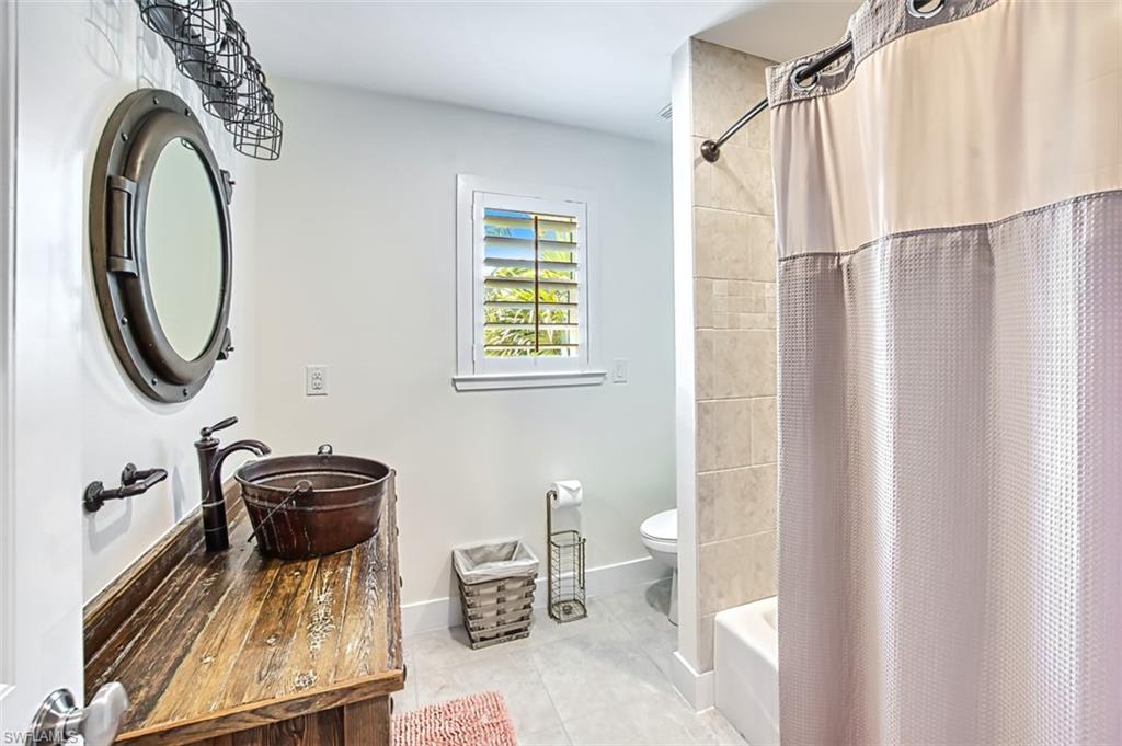Bedroom with a ceiling fan and light tile patterned floors