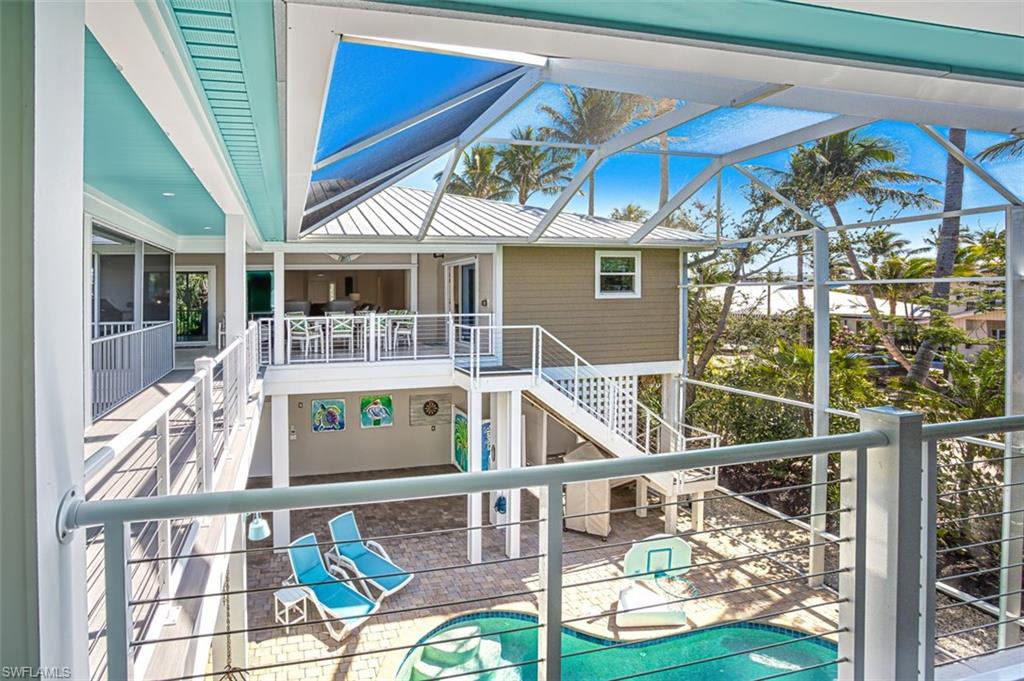 View of patio with outdoor dining area and a ceiling fan