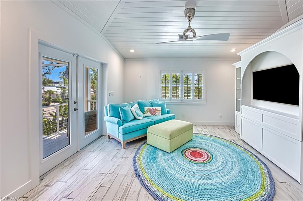Sitting room with french doors, vaulted ceiling, recessed lighting, wood tiled floors, and a ceiling fan
