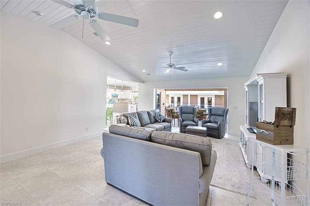 Living area featuring recessed lighting, light tile patterned floors, wood ceiling, high vaulted ceiling, and a ceiling fan