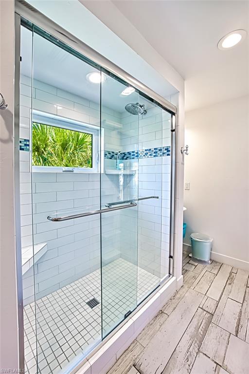 Full bath with a walk in closet and a shower stall