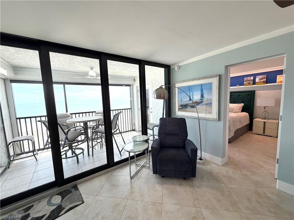 Sliding glass doors to balcony provide abundant light and sunset views