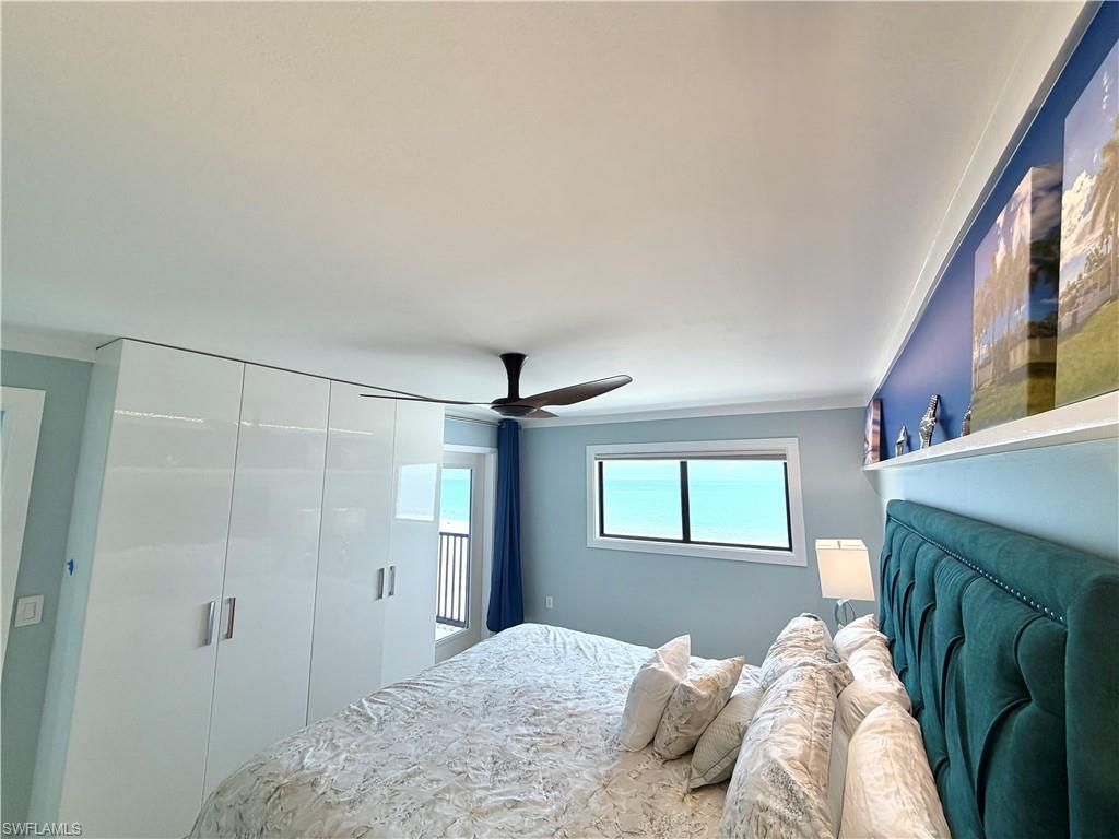 Recessed lighting with crown molding, ceiling fan, tile flooring, and built-in closet system