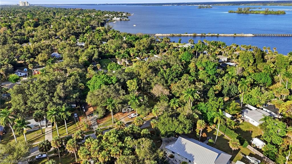 Aerial view of residential area featuring property parcel outlined and a large body of water