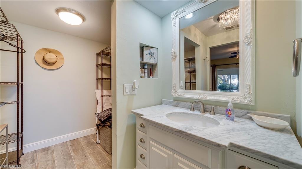 Full bathroom with vanity and light wood finished floors