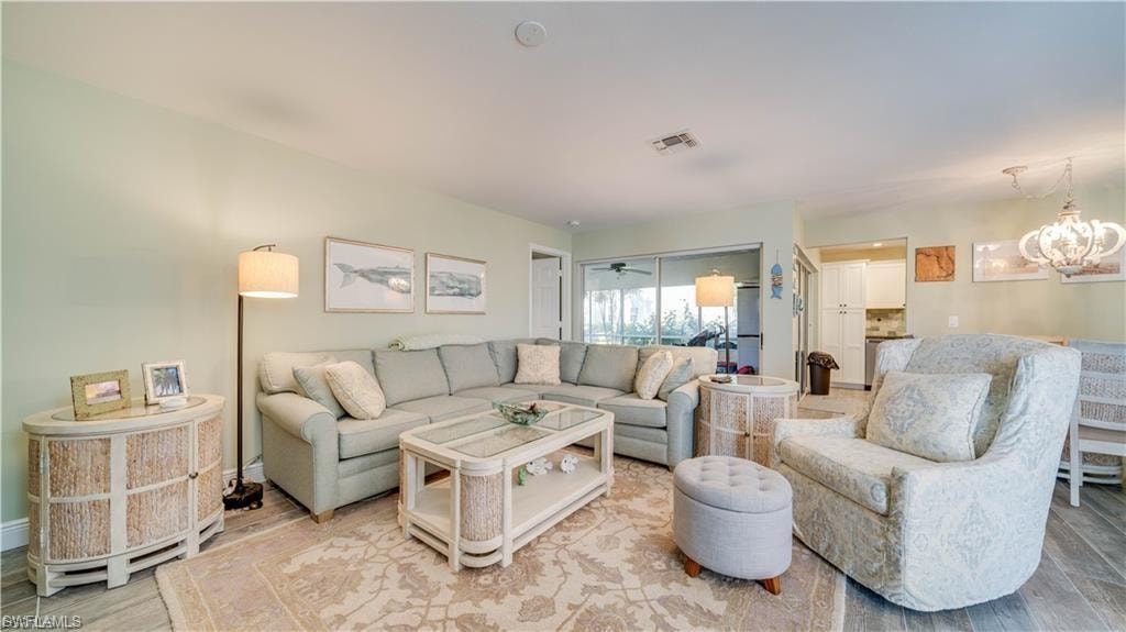 Living room with wood finished floors and a chandelier
