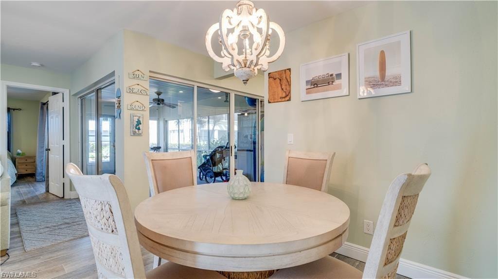Dining space featuring wood finished floors and a chandelier