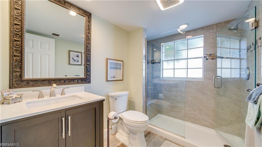 Bathroom with vanity and a shower stall