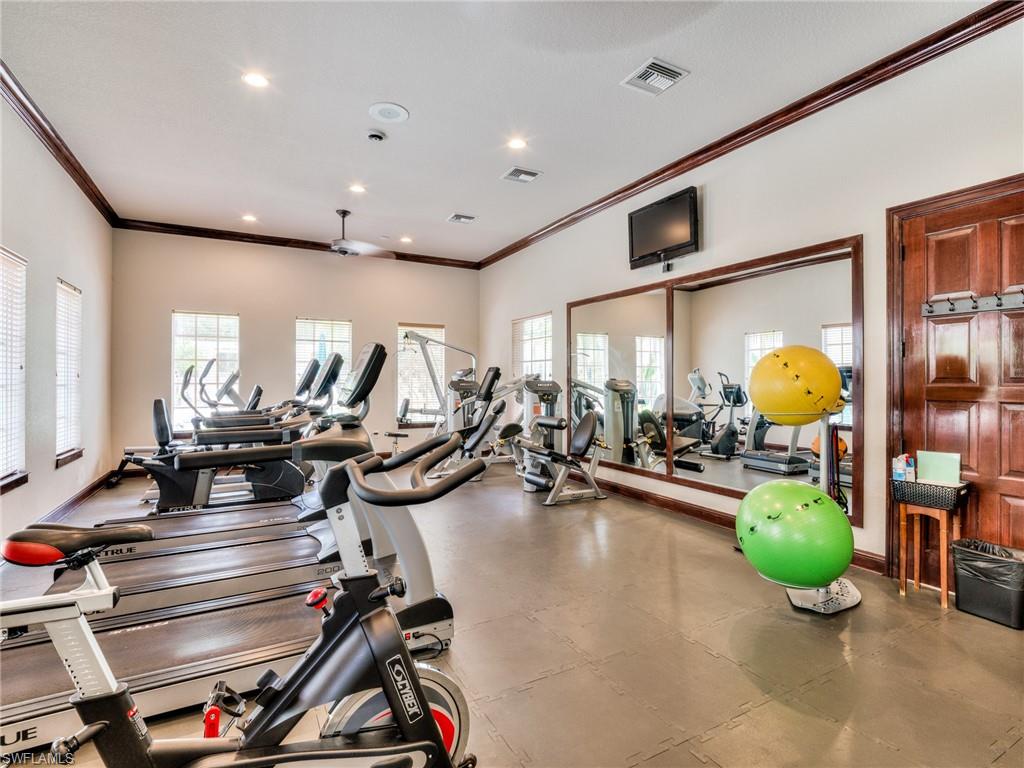 Workout area with crown molding and recessed lighting