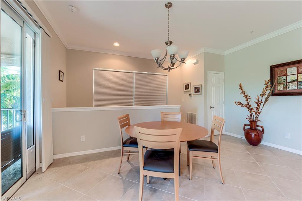 Dining room with crown molding, light tile patterned flooring, plenty of natural light, a chandelier, and recessed lighting