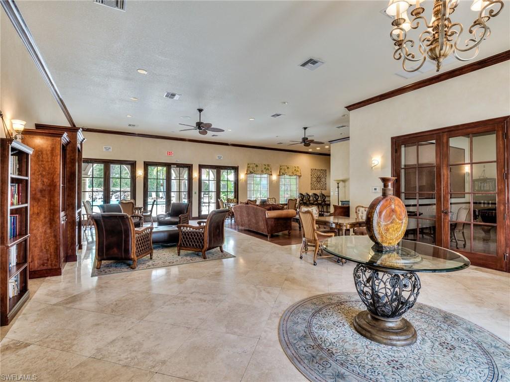 Living room with french doors, ornamental molding, a chandelier, and ceiling fan