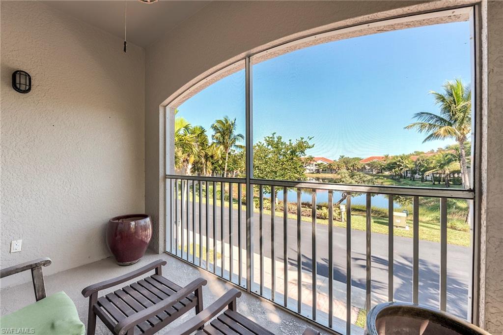Balcony with a sunroom and a water view