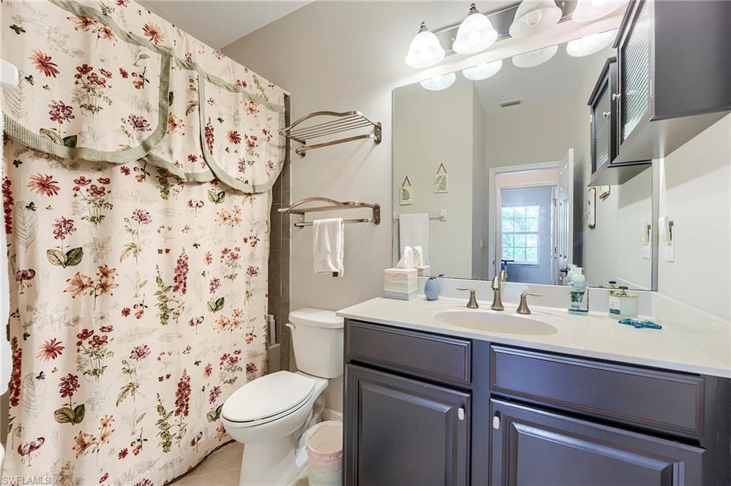 Full bathroom featuring a shower with shower curtain and vanity