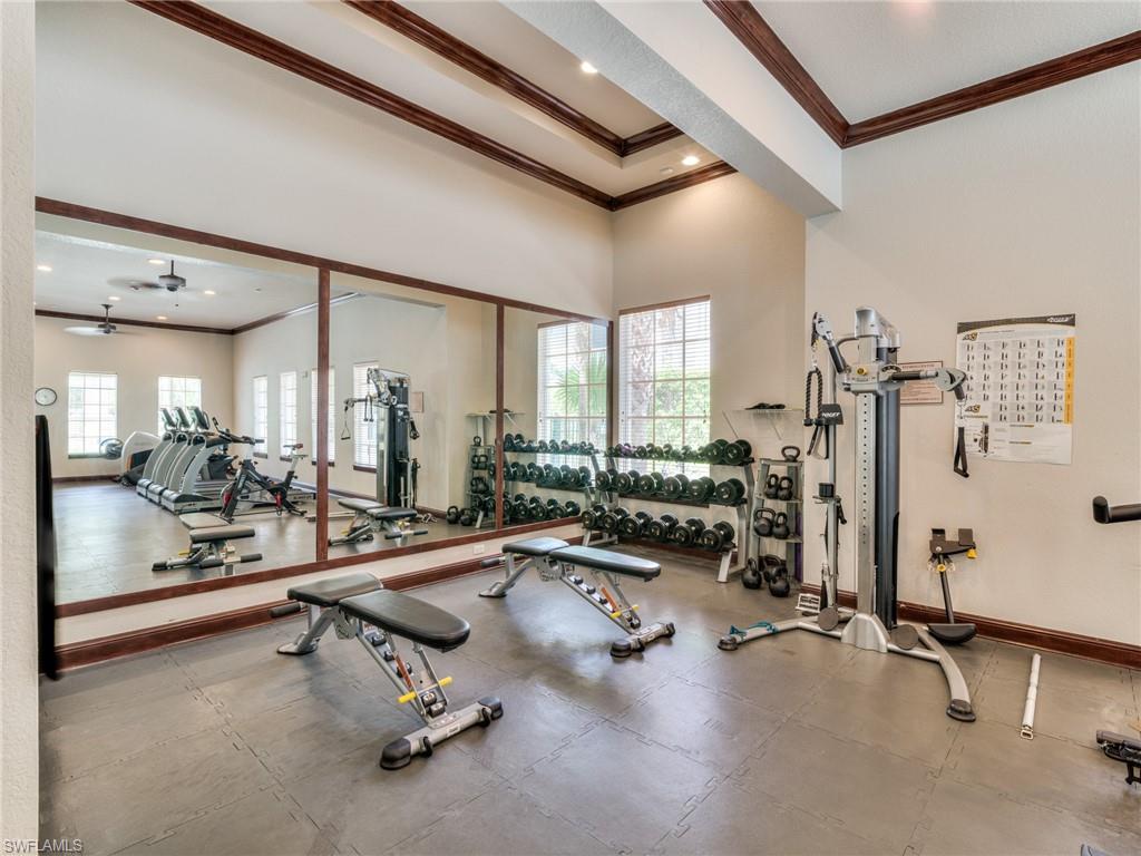Exercise room featuring crown molding, a towering ceiling, recessed lighting, and a ceiling fan
