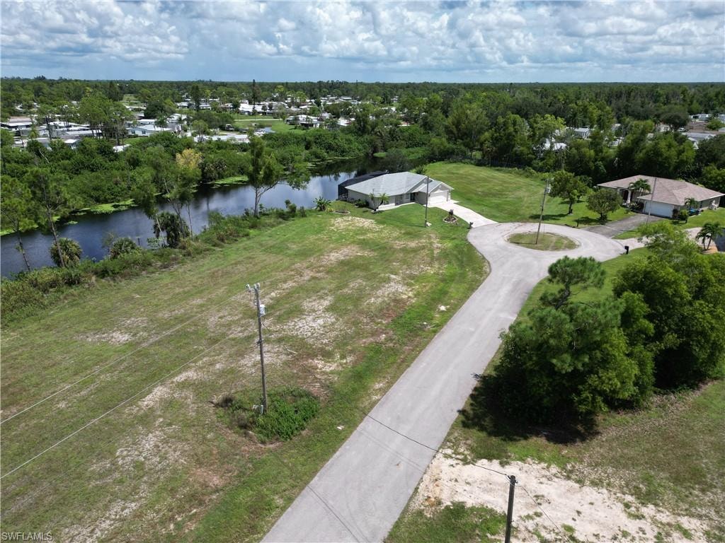 Birds eye view of property with a water view