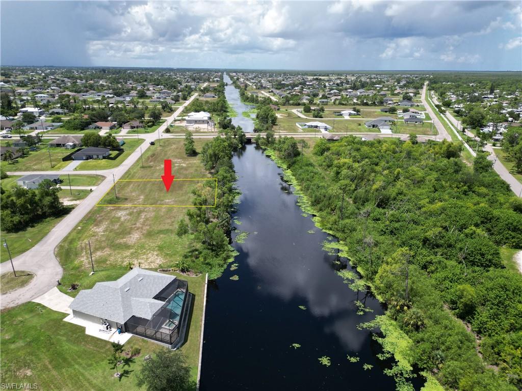 Birds eye view of property with a water view