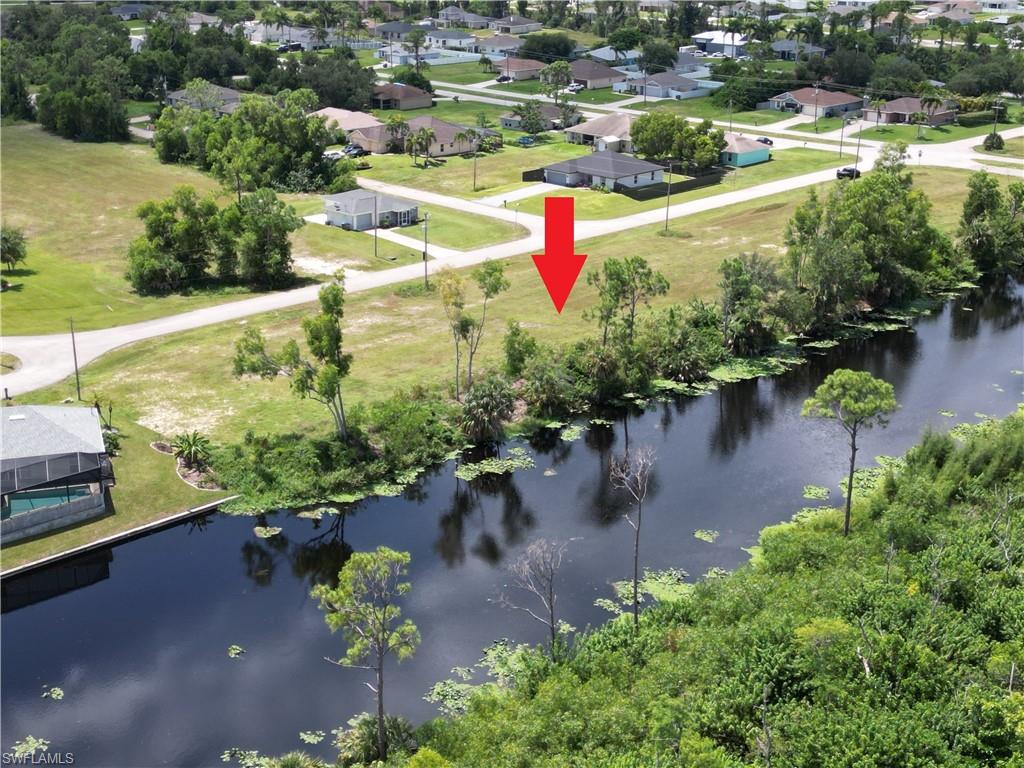 Birds eye view of property with a water view