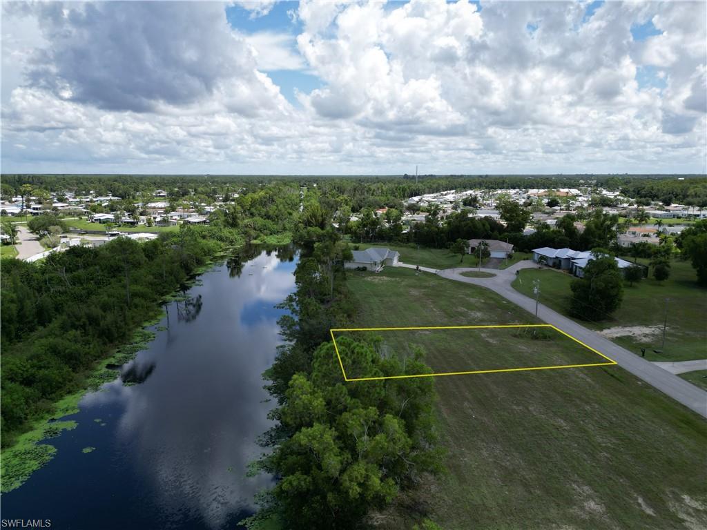 Birds eye view of property with a water view