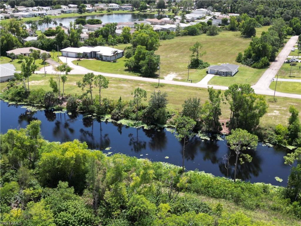 Birds eye view of property with a water view