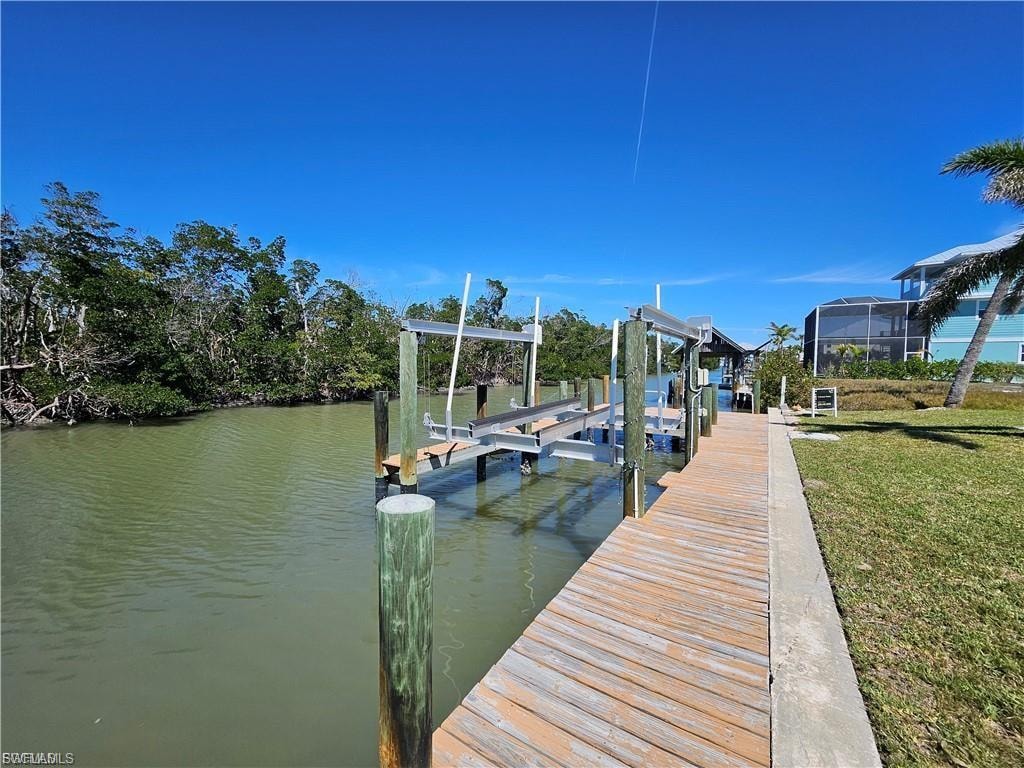 Dock area with boat lift and a water view